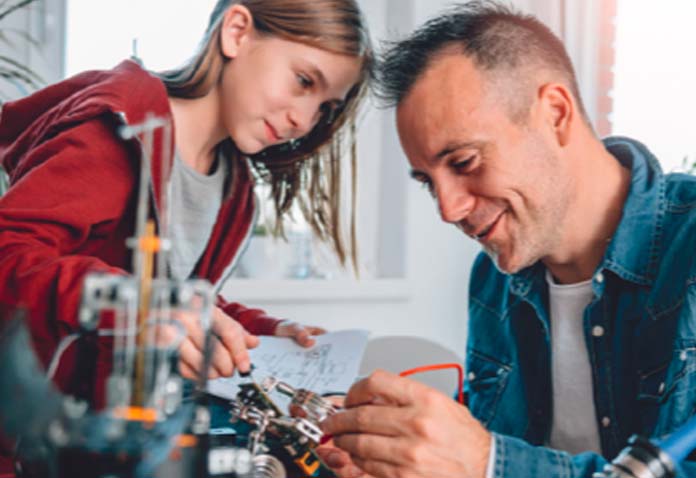 A father and child doing a tech project