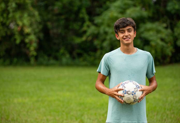 A boy holding a soccer ball